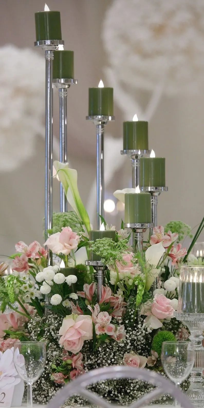 Glassy 8 Head Rotating Candelabra with green candles and flowers