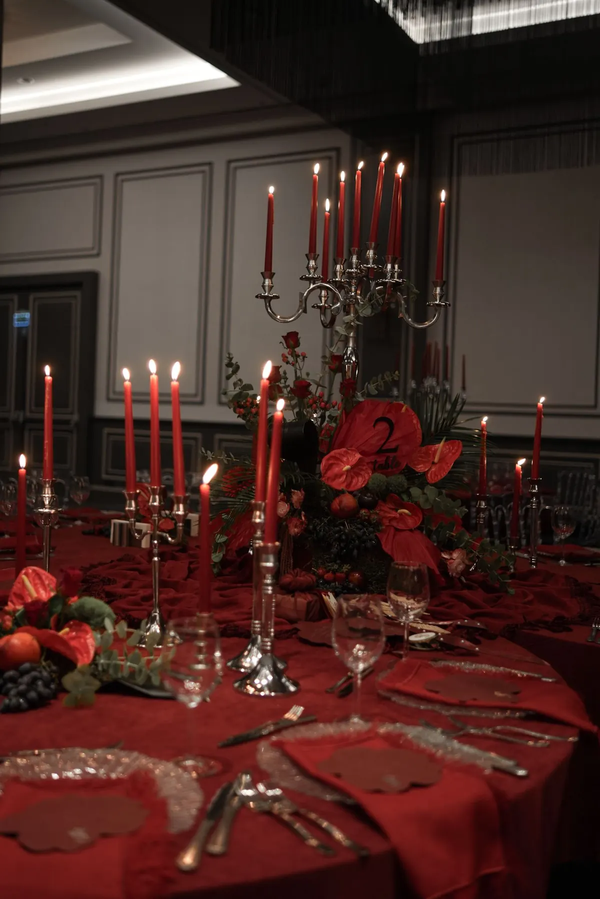 Glassy fork candleholder with red candles on a wedding table
