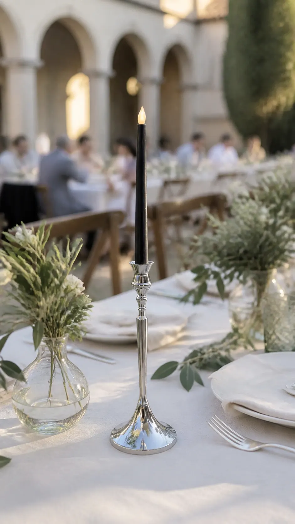 Classic candleholder outdoors Classic Glassy candleholder with a black candle at an outdoor wedding