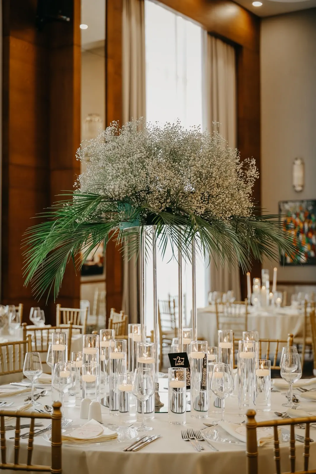 Acrylic stand as a table centrepiece Wedding table with acrylic flower stand and glass candle cylinders